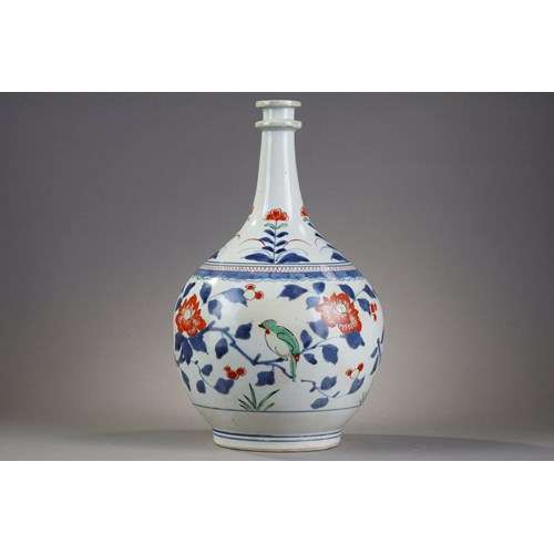 Bottle pharmacy with double ring collar. porcelain decorated in blue under cover and polychrome enamels of birds among the branches of pomegranate peony and camellia Japan  Arita  kilns late 17th century