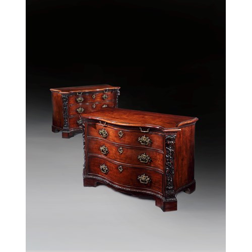 A highly important pair of serpentine fronted mahogany commodes