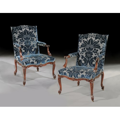 A pair of mahogany open armchairs