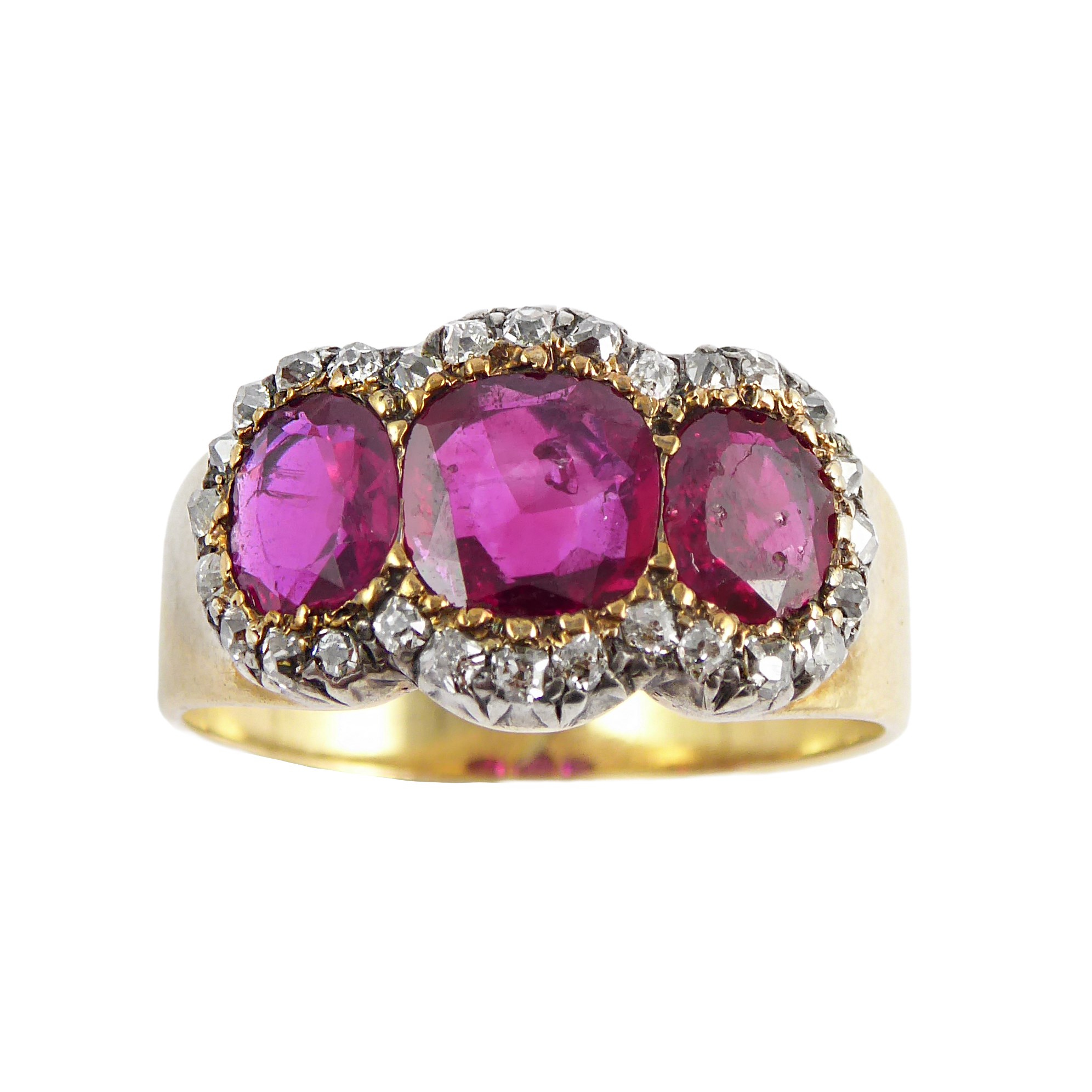 Three stone cushion cut ruby in diamond cluster ring