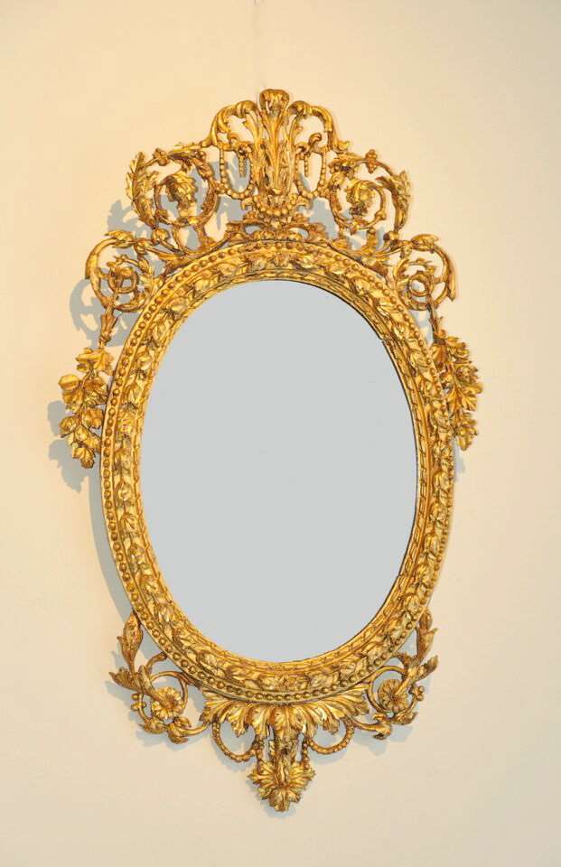 A Pair of Neoclassical micro-sculpted Italian Giltwood oval Mirrors