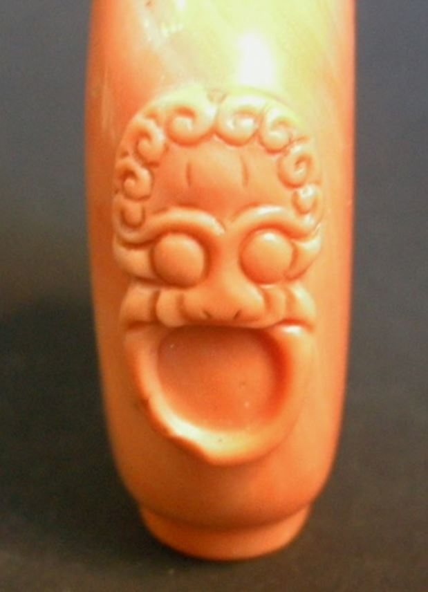 Rare coral snuff bottle sculpted with mask and ring handles | MasterArt