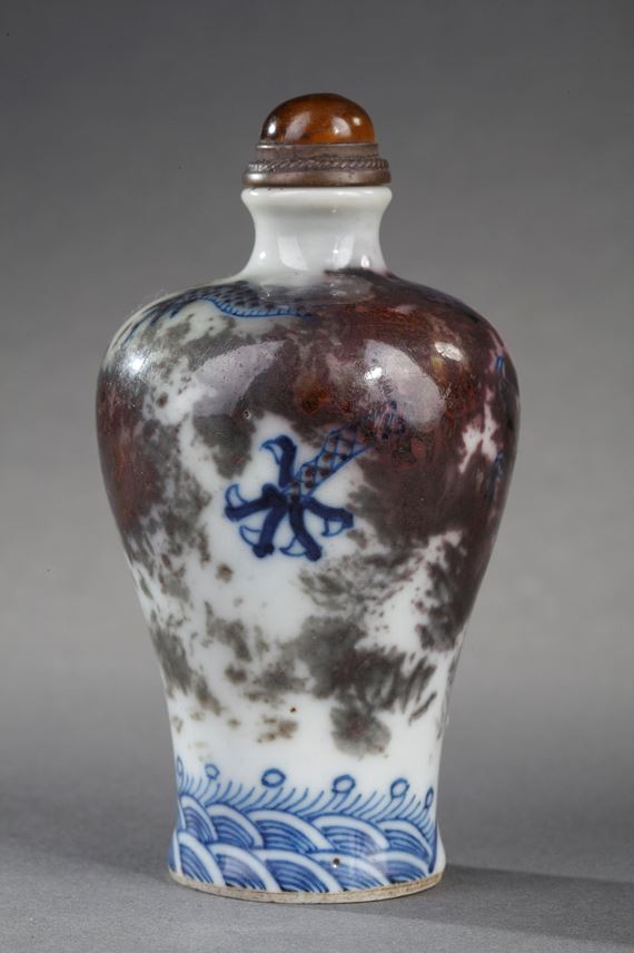 Snuff bottle porcelain enamelled in underglaze blue and copper red decorated with a Dragon in a clouds | MasterArt