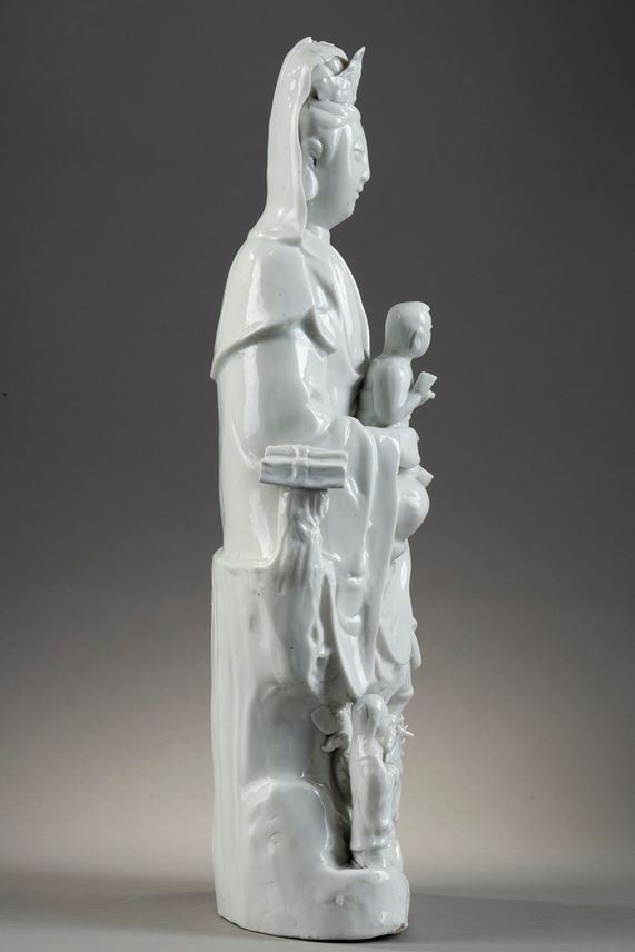 Large figure Blanc de Chine porcelain of Guanyin and children with its attendants and dragons | MasterArt