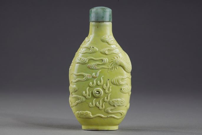 Snuff bottle porcelain enamelled yellow molded and sculpted with a dragon | MasterArt