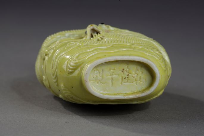 Snuff bottle porcelain enamelled yellow molded and sculpted with a dragon | MasterArt