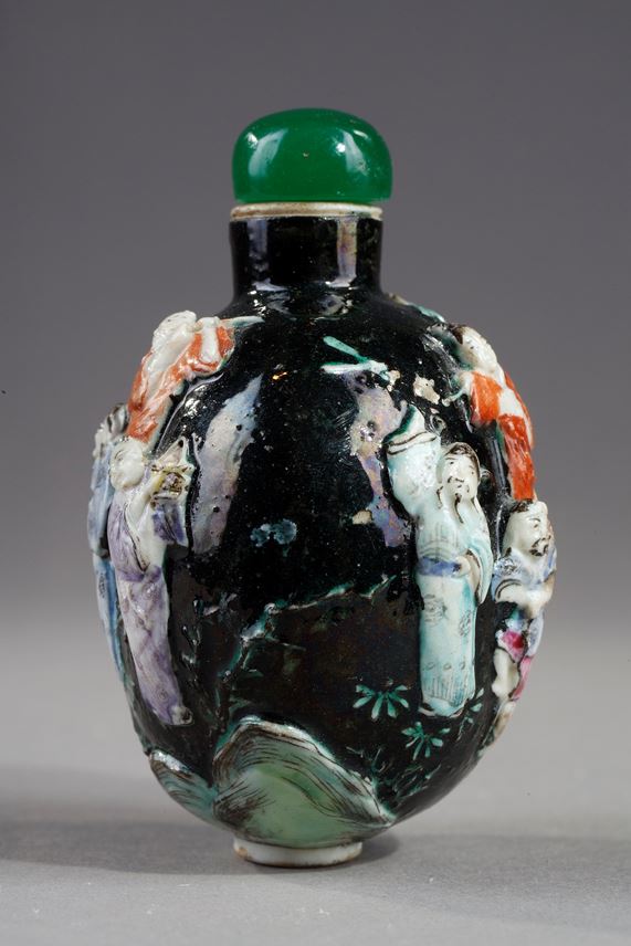 Snuff bottle porcelain molded with eight immortals on a dark green background | MasterArt