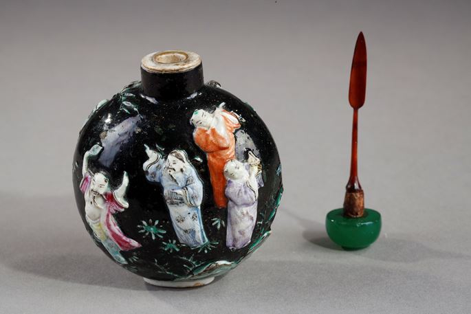 Snuff bottle porcelain molded with eight immortals on a dark green background | MasterArt