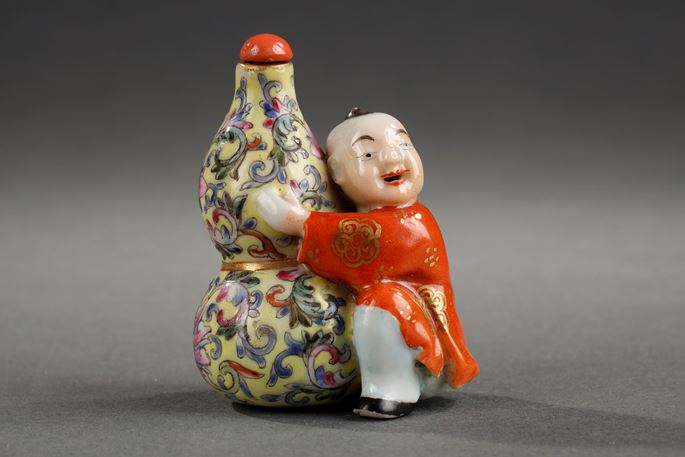 Snuff bottle porcelain in shape of a children holding a double gourd | MasterArt