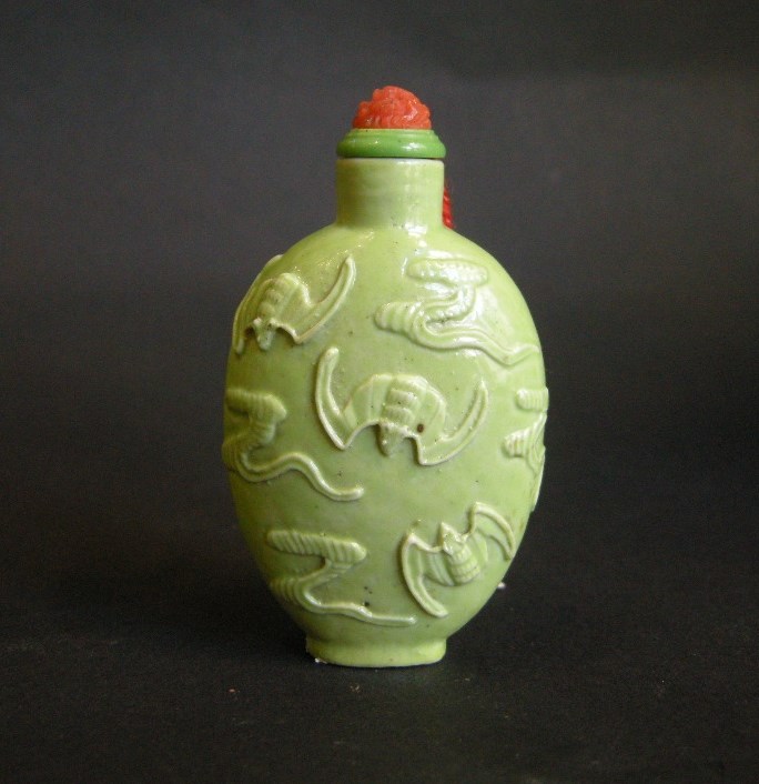 Porcelain snuff bottle in green monochrom sculpted in Wang Bingrong style