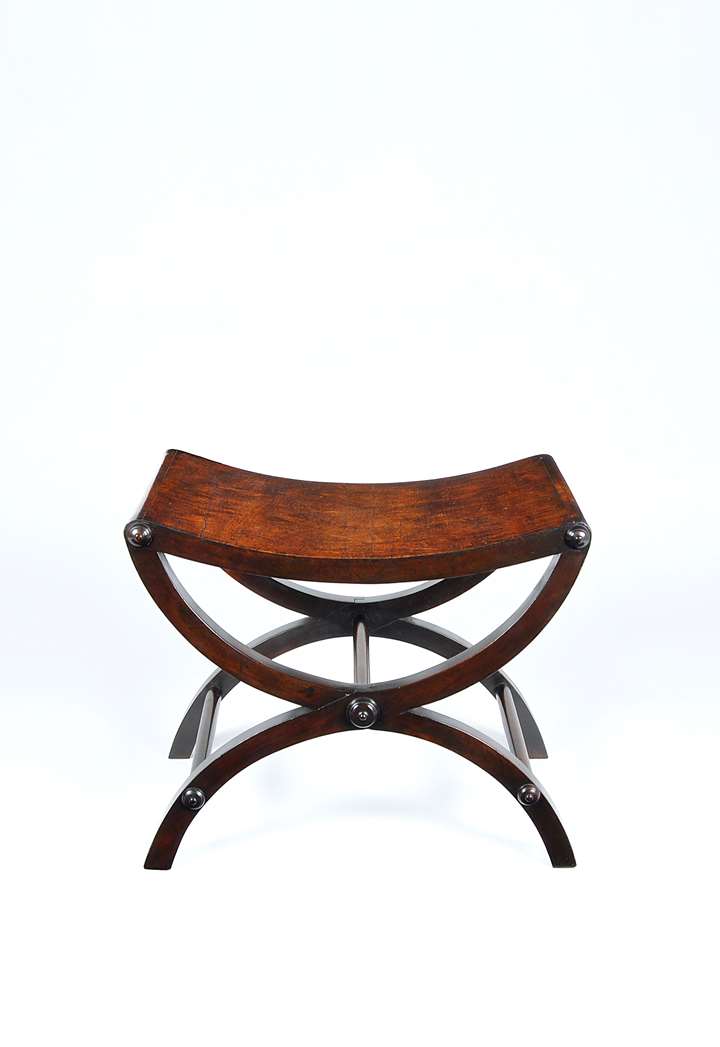 A fine mahogany X framed stool