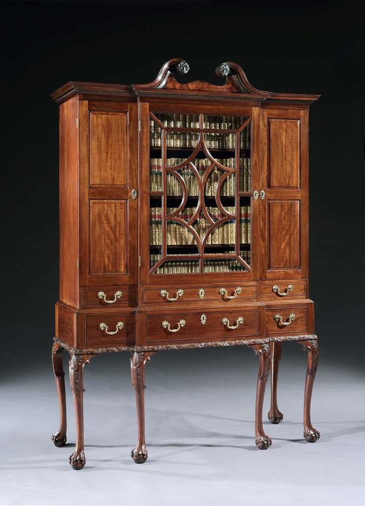 A GEORGE II MAHOGANY BREAKFRONT SECRÉTAIRE CABINET ON STAND