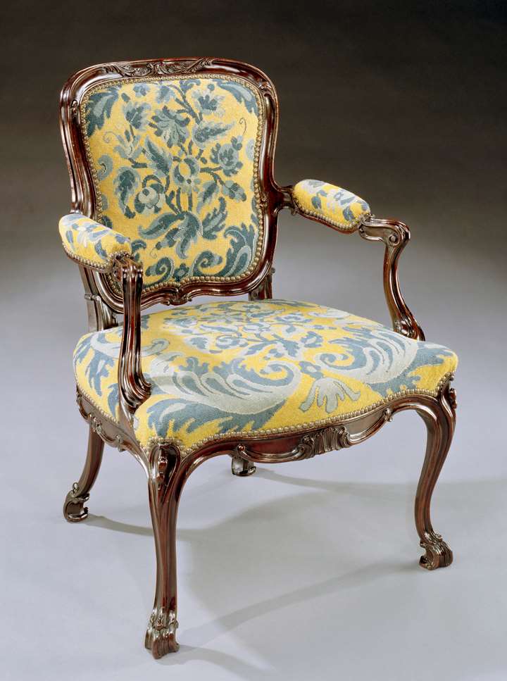 A GEORGE III CARVED MAHOGANY NEEDLEWORK ARMCHAIR