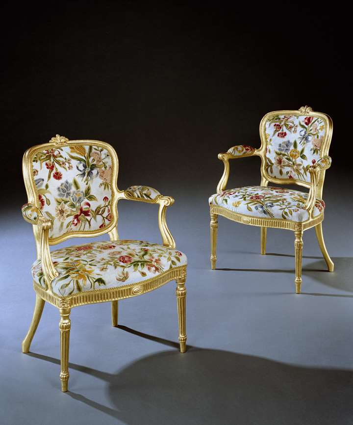 A PAIR OF GEORGE III GILTWOOD ARMCHAIRS