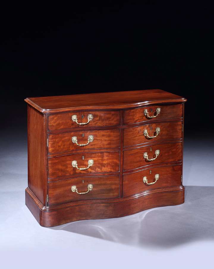 A GEORGE III MAHOGANY COMMODE ATTRIBUTED TO JOHN BRADBURN