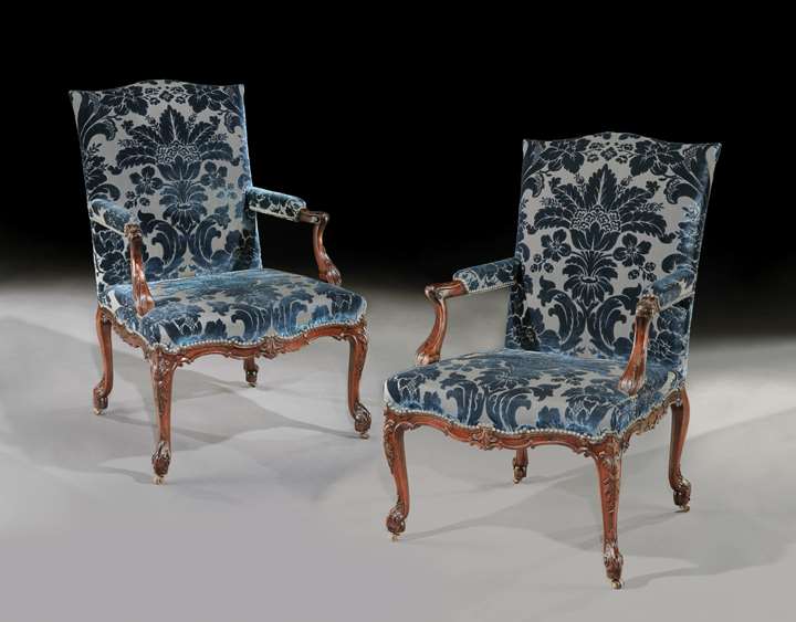 A pair of mahogany open armchairs
